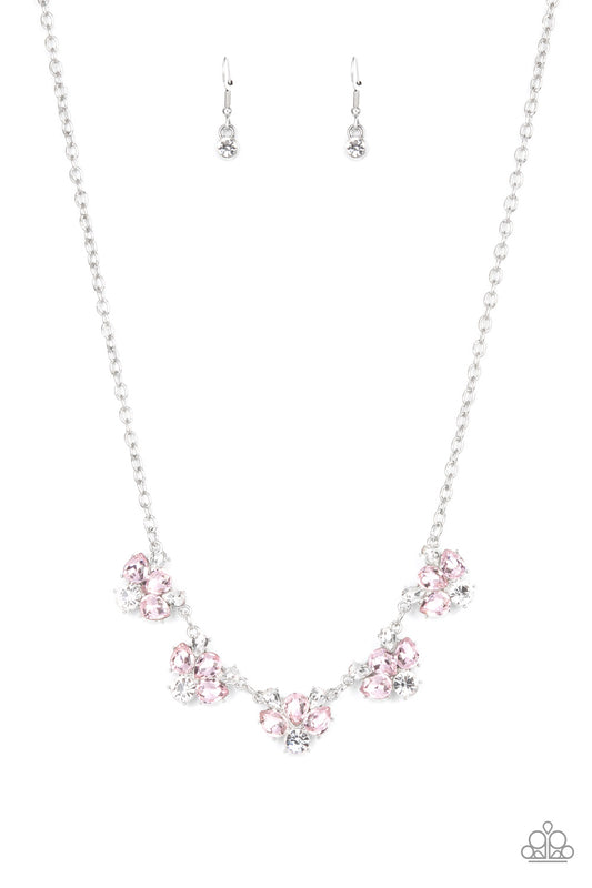 Featuring round and teardrop cuts, white and pink rhinestones delicately link into a sparkling statement piece that results into an envious glow below the collar. Features an adjustable clasp closure.  Sold as one individual necklace. Includes one pair of matching earrings.