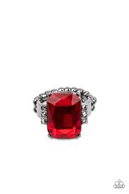 Flanked by stacks of dainty hematite rhinestones, an oversized fiery red emerald cut gem is pressed into the center of a sleek gunmetal frame, resulting in a dramatic centerpiece atop the finger. Features a dainty stretchy band for a flexible fit.  Sold as one individual ring.