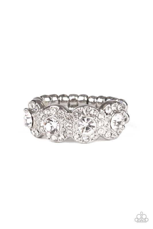 Bordered in rings of dainty white rhinestones, four classic white rhinestones are encrusted along the front of a dainty silver band for a timeless shimmer. Features a dainty stretchy band for a flexible fit.  Sold as one individual ring.