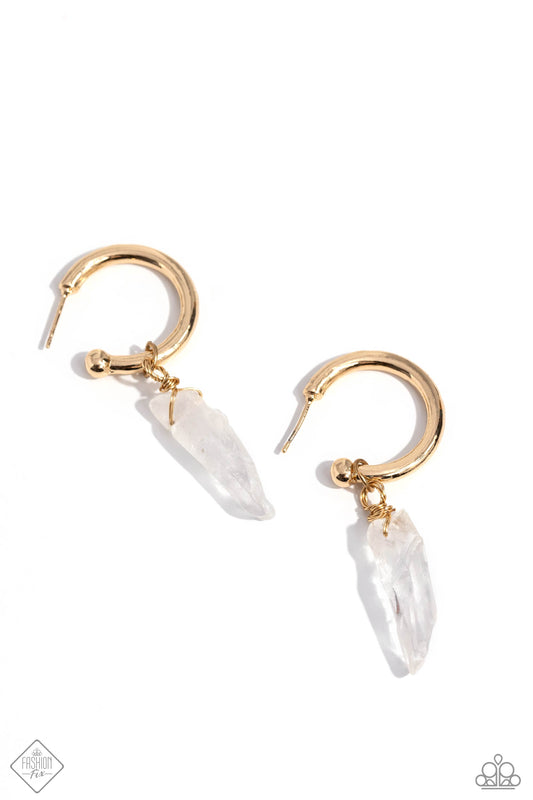 A small, skinny, gold hoop curves around the ear in a timeless fashion. A gold ball is affixed to the end of the hoop, reminiscent of a barbell fitting. Delicately attached to gold wire, a chiseled piece of clear white stone slides along the curvature of the hoop, adding a surprising hint of stony movement. Earring attaches to a standard post fitting. Hoop measures approximately 3/4" in diameter. As the stone elements in this piece are natural, some color variation is normal.