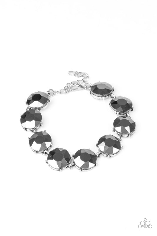 Nestled inside classic silver fittings, a collection of oversized hematite rhinestones delicately link around the wrist for a flashy finish. Features an adjustable clasp closure.

Sold as one individual bracelet.