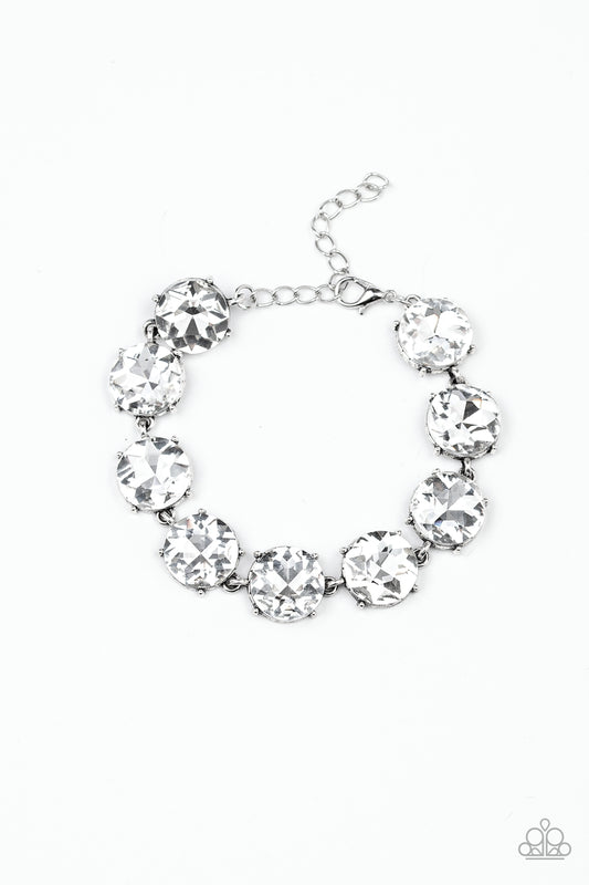 Nestled inside classic silver fittings, a collection of oversized white rhinestones delicately link around the wrist for a flashy finish. Features an adjustable clasp closure.

Sold as one individual bracelet.