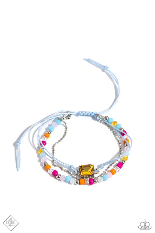 Featuring a flashy faceted finish, multicolored beads, seed beads, silver accents, and clear beads are strung along a strand of blue cording. The varying opacities of each bead add depth to the design, as a strand of silver ball chain adds metallic sheen. An emerald-cut yellow gem, pressed in a silver pronged fitting, is tied to the centermost strand of blue cording, creating a three-in-one colorful stack. Features an adjustable sliding knot closure.  Sold as one individual bracelet.
