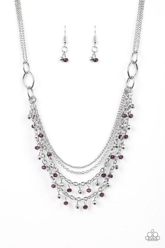 Dainty silver and purple crystal-like beads cascade from two shimmery silver chains. Infused with plain silver chains, the colorful strands layer below the collar for a flirtatious look. Features an adjustable clasp closure.  Sold as one individual necklace. Includes one pair of matching earrings.