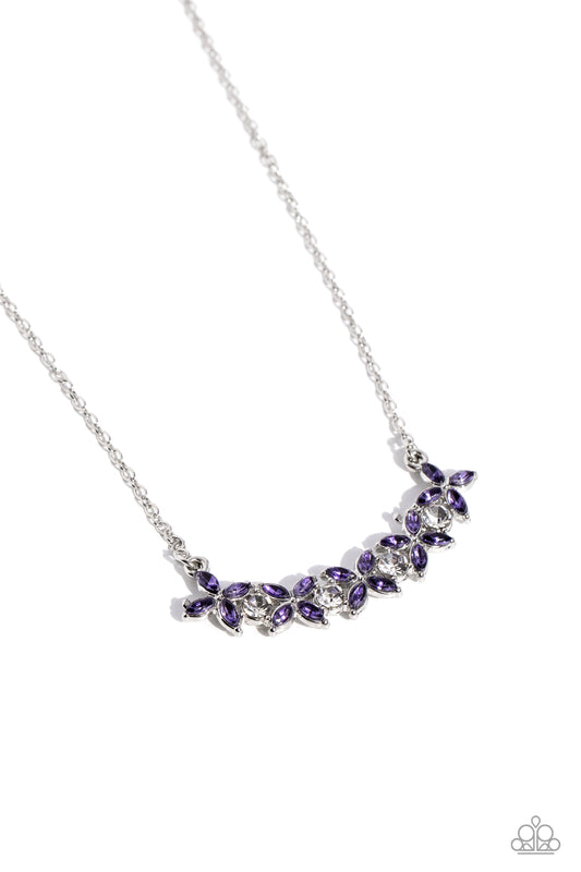 Gliding from a dainty silver chain, an alluring arrangement of white round rhinestones, and dainty, purple, marquise-cut petals formed into flowers cluster below the neckline for a subtle shimmer. Features an adjustable clasp closure.  Sold as one individual necklace. Includes one pair of matching earrings.