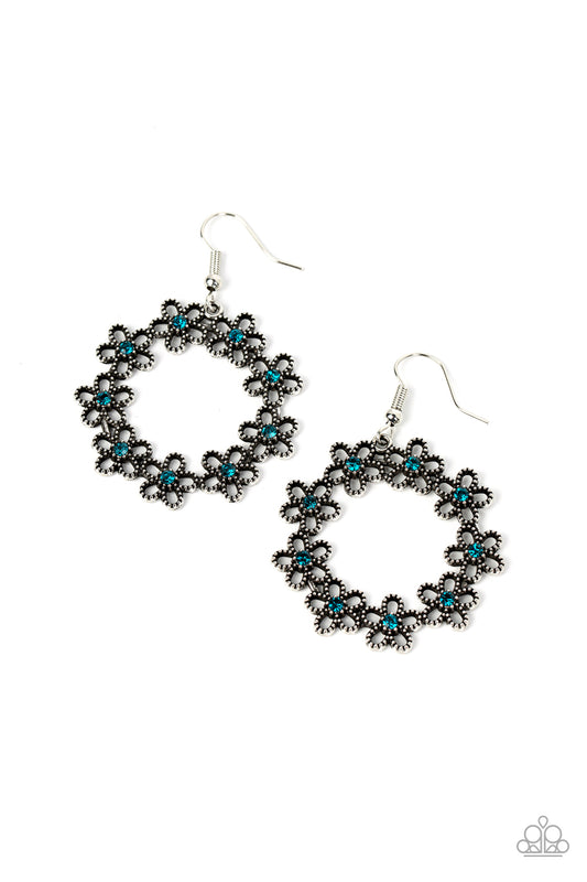 Dotted with dainty blue rhinestone centers, studded silver flowers delicately connect into a whimsical floral wreath for a seasonal fashion. Earring attaches to a standard fishhook fitting.  Sold as one pair of earrings.