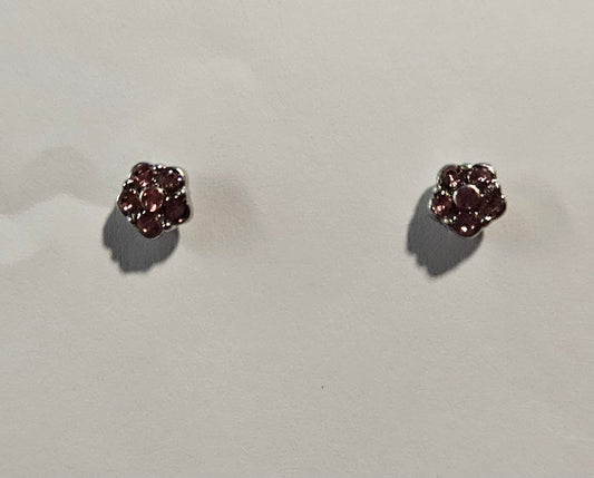 Silver flower shaped earrings with pink rhinestones