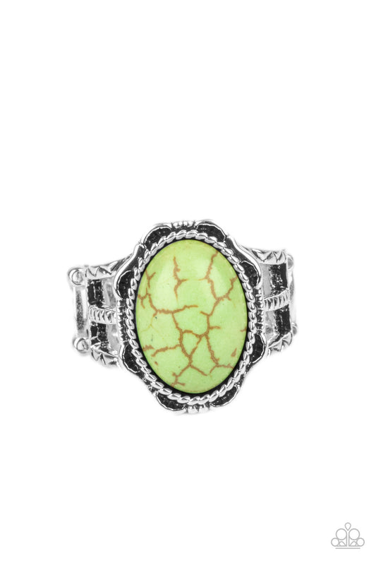 An oval green stone is pressed into the center of a silver studded floral frame, creating a colorful centerpiece atop the finger. Features a stretchy band for a flexible fit.  Sold as one individual ring.