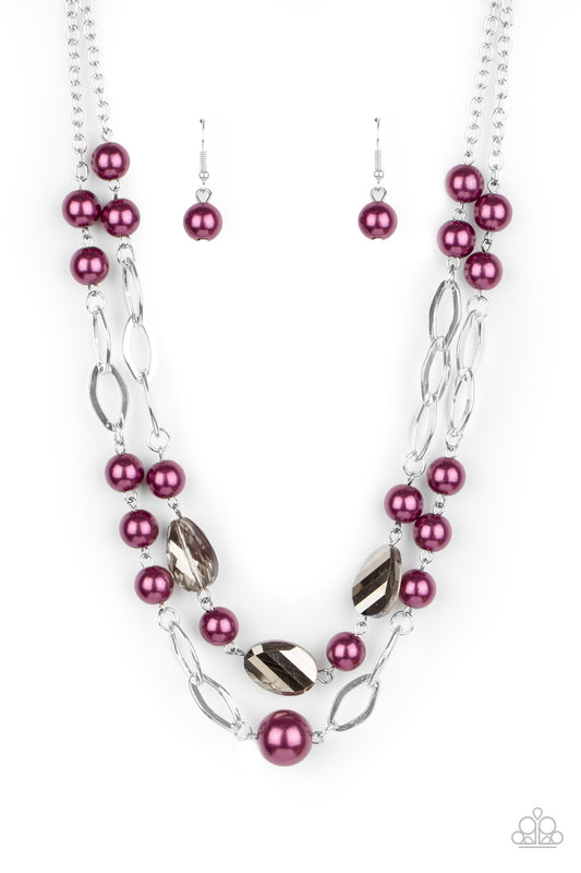 A mismatched collection of pearly purple beads, shimmery silver ovals, and metallic flecked crystal-like gems link into two polished rows below the collar, creating colorfully timeless layers. Feature an adjustable clasp closure.  Sold as one individual necklace. Includes one pair of matching earrings.