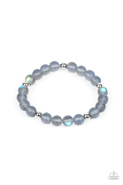 Infused with silver accents, a glassy collection of opaque blue beads are threaded along a stretchy band around the wrist for a dreamy glow.  Sold as one individual bracelet.