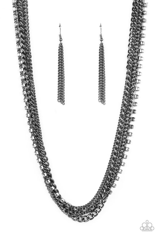 A mashup of gunmetal chains collides with a strand of sparkling white rhinestones encased in gunmetal fittings. The contrast of gritty gunmetal finishes and shimmery accents creates a brilliant display of grunge and glitz as the strands layer across the chest in an epic finish. Features an adjustable clasp closure.  Sold as one individual necklace. Includes one pair of matching earrings.