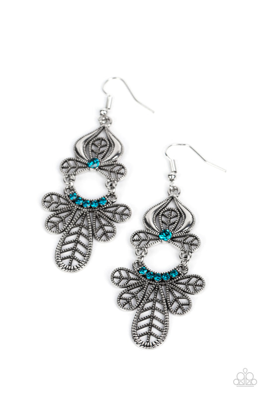 Studded leafy frames flare out from the bottom of a curved row of glittery blue rhinestones that swings from the bottom of a matching leafy silver frame. A solitaire blue rhinestone dots the uppermost frame, adding a collective shimmer to the seasonal chandelier. Earring attaches to a standard fishhook fitting.  Sold as one pair of earrings.