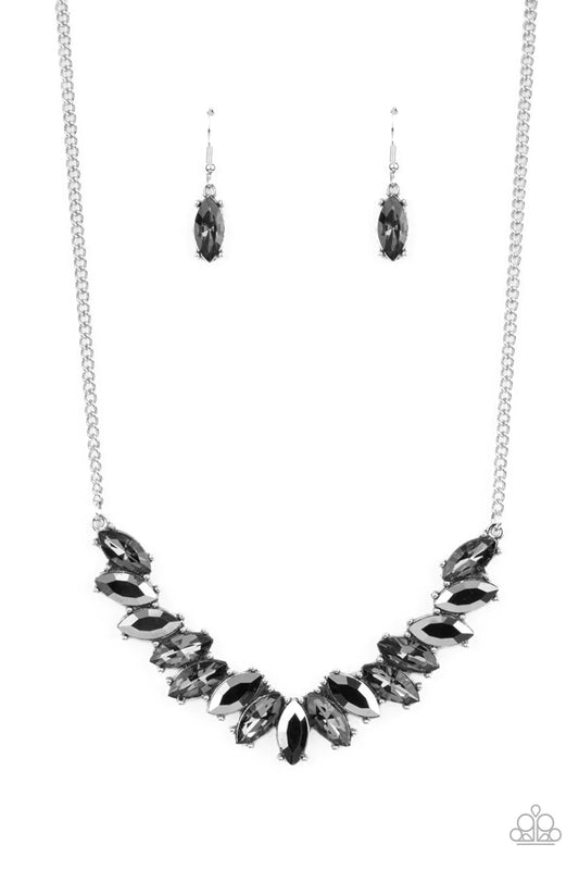 Featuring pronged silver fittings, a sparkly series of smoky and hematite marquise cut rhinestones fan out below the collar for a stellar statement-making look. Features an adjustable clasp closure.  Sold as one individual necklace. Includes one pair of matching earrings.