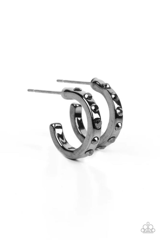 The front edge of a shiny gunmetal hoop is decorated in a sparkly collection of tiny hematite rhinestones for a gritty finish. Earring attaches to a standard post fitting. Hoop measures approximately 1/2" in diameter.  Sold as one pair of hoop earrings.