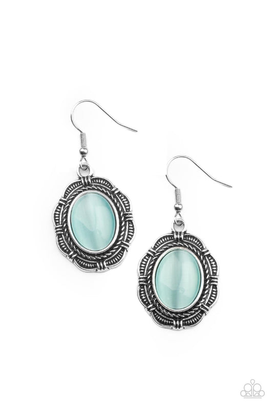 An oval Cerulean cat's eye stone is pressed into the center of a textured silver floral frame, creating a whimsical centerpiece. Earring attaches to a standard fishhook fitting.  Sold as one pair of earrings.