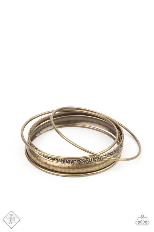 A mismatched collection of smooth, hammered, and textured brass bangles stack up the wrist for an edgy, industrial effect.  Sold as one set of five bracelets.