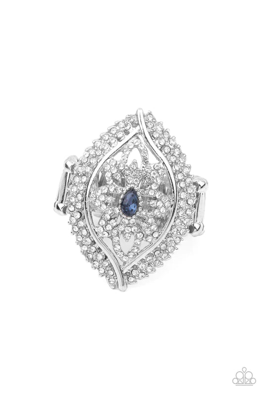 Encrusted in icy white rhinestones, glittery silver petals bloom from a sparkly blue teardrop rhinestone center, creating a glamorous centerpiece inside a frame of dramatically double-bordered rows of white rhinestones. Features a stretchy band for a flexible fit.  Sold as one individual ring.