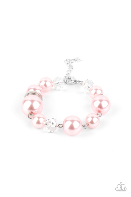 A glamorous collection of white crystal-like beads, shiny silver ovals, and oversized pink pearls delicately link around the wrist creating an effortless glow. Features an adjustable clasp closure.

Sold as one individual bracelet.