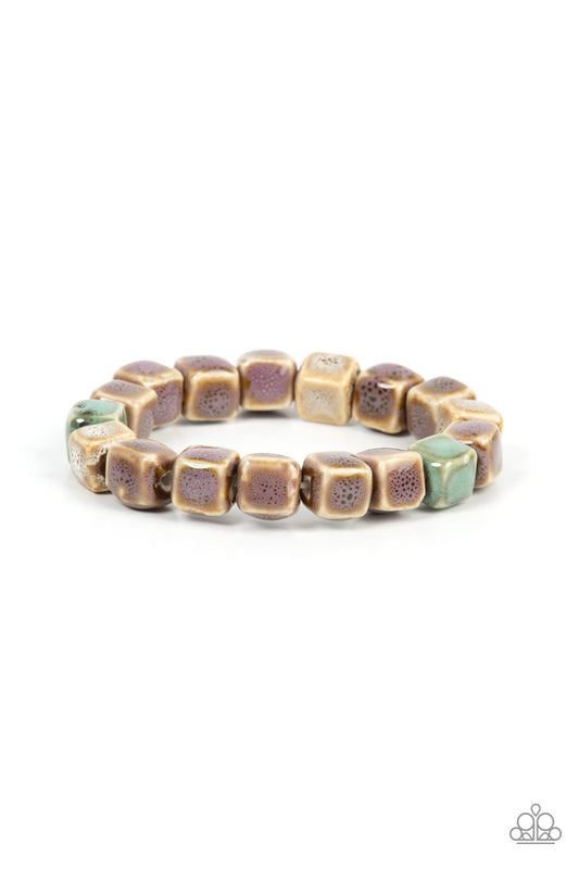 Featuring distressed purple, blue, and brown glazed finishes, a rustic collection of ceramic cube beads are threaded along stretchy bands around the wrist for a colorful flair. Due to the nature of the materials, some color variation is normal.  Sold as one individual bracelet.