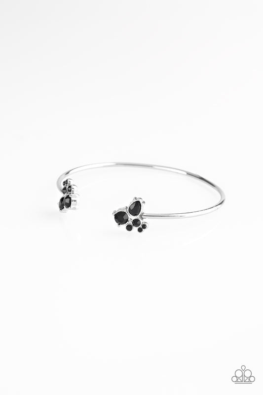 Varying in shape, glittery black rhinestones join at both ends of a dainty silver cuff, creating refined fittings.  Sold as one individual bracelet.