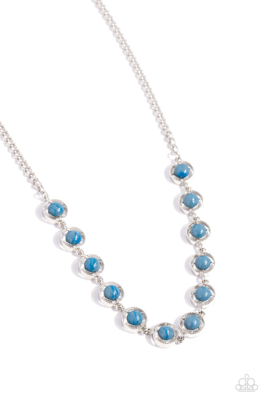 A dainty series of serrated silver rings are fitted with pronged blue beaded centers as they delicately link below the collar from a classic silver chain, resulting in a seasonal statement. Features an adjustable clasp closure.  Sold as one individual necklace. Includes one pair of matching earrings.