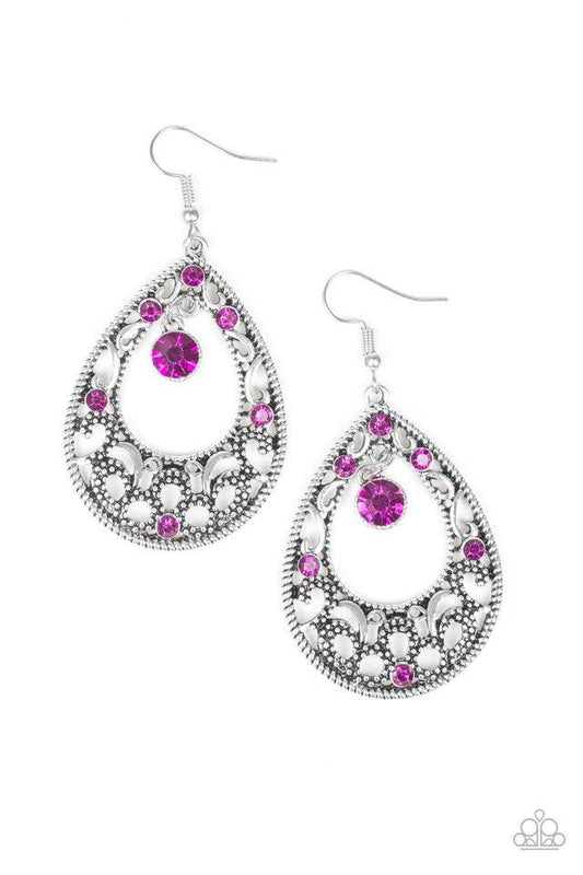 Glistening and studded silver filigree swirls along a shimmery silver frame radiating with glittery pink rhinestones. A sparkling pink rhinestone swings from the top of the frame for a refined finish. Earring attaches to a standard fishhook fitting.  Sold as one pair of earrings.