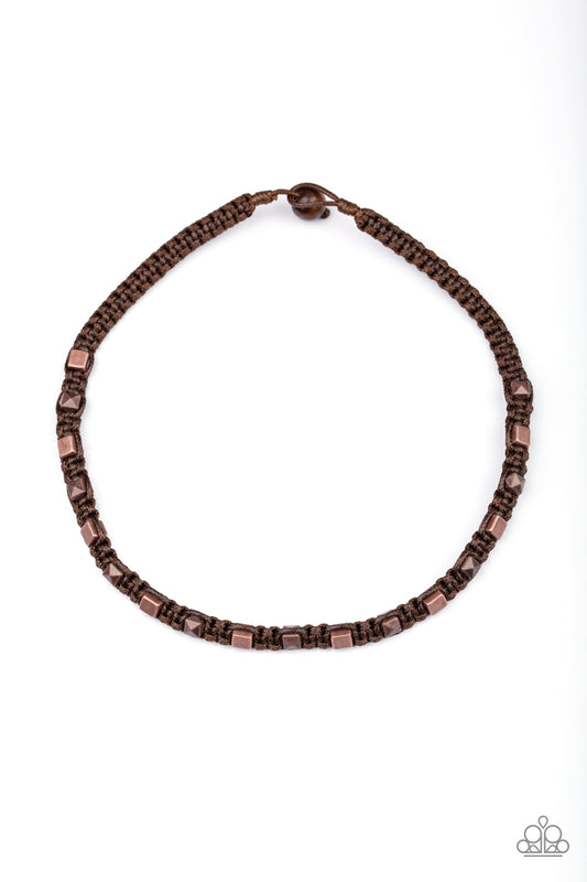 A collection of square and faceted copper beads are knotted in place along a braided brown cord for an urban look below the collar. Features a button loop closure.  Sold as one individual necklace.