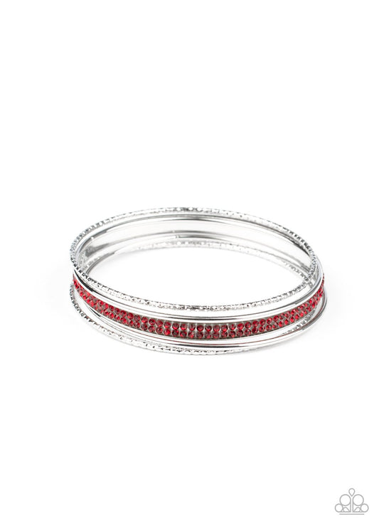 Pairs of smooth and hammered silver bangles join a red rhinestone encrusted bracelet around the wrist, creating an edgy stack of sparkle.  Sold as one set of five bracelets.
