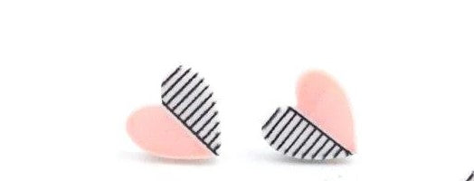 Kids' heart shaped earrings with pink on one half and black and white stripes on the other half