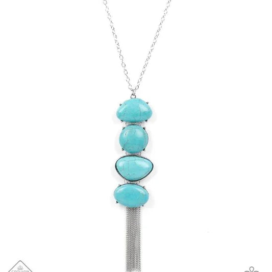 Stacked turquoise stones create an oversized pendant that sways from the bottom of a lengthened silver chain. The irregular-shaped stones add artisanal character while a flirty fringe of dainty chains adds playful energy. Features an adjustable clasp closure.  Sold as one individual necklace. Includes one pair of matching earrings.