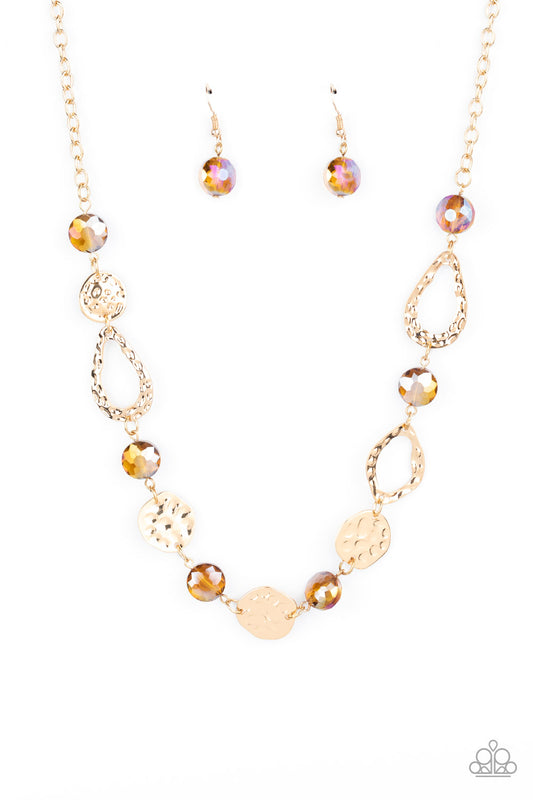 Hammered gold frames and imperfect gold ovals link with iridescent topaz gems below the collar, creating a colorful display. Features an adjustable clasp closure.  Sold as one individual necklace. Includes one pair of matching earrings.