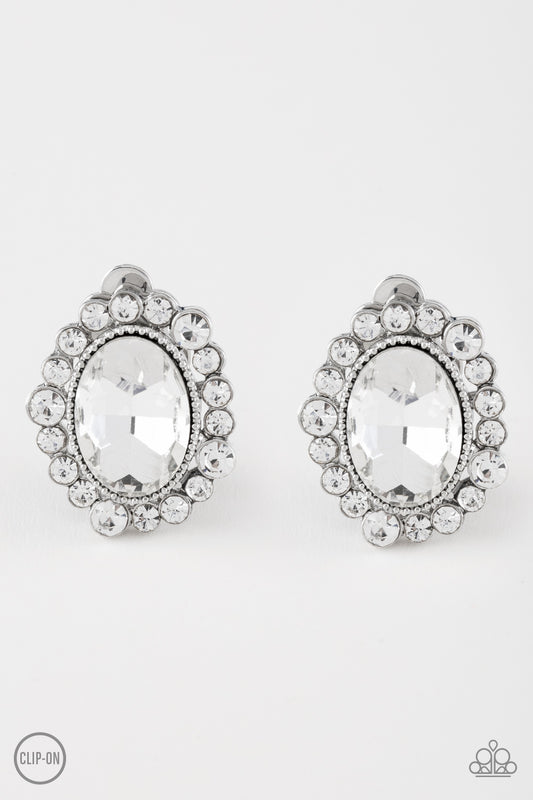 Varying in size, dainty white rhinestones spin around a faceted white gem for a timeless look. Earring attaches to a standard post fitting.  Sold as one pair of post earrings.