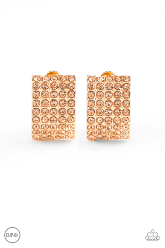Encrusted in row after row of glittery peach rhinestones, a radiant gold ribbon curls around the ear for a glamorous look. Earring attaches to a standard clip-on fitting.  Sold as one pair of clip-on earrings.