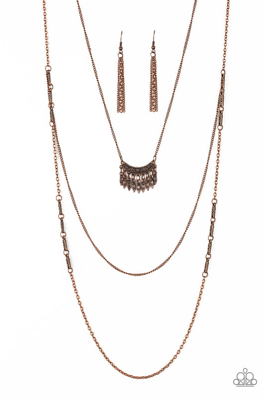 Embossed in a whimsical floral pattern, a fringed frame swings from the uppermost chain above a copper chain featuring dainty copper beading. Infused with a plain chain, the glistening copper chains layer down the chest for a seasonal look. Features an adjustable clasp closure.

Sold as one individual necklace. Includes one pair of matching earrings.