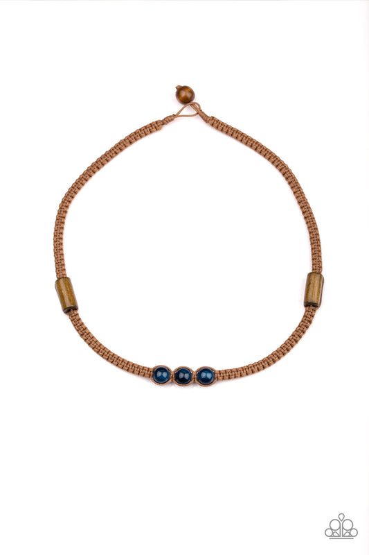 An assortment of wooden accents and glassy blue beads are knotted in place along a braided cord, creating a seasonal look below the collar. Features a button loop closure.  Sold as one individual necklace.
