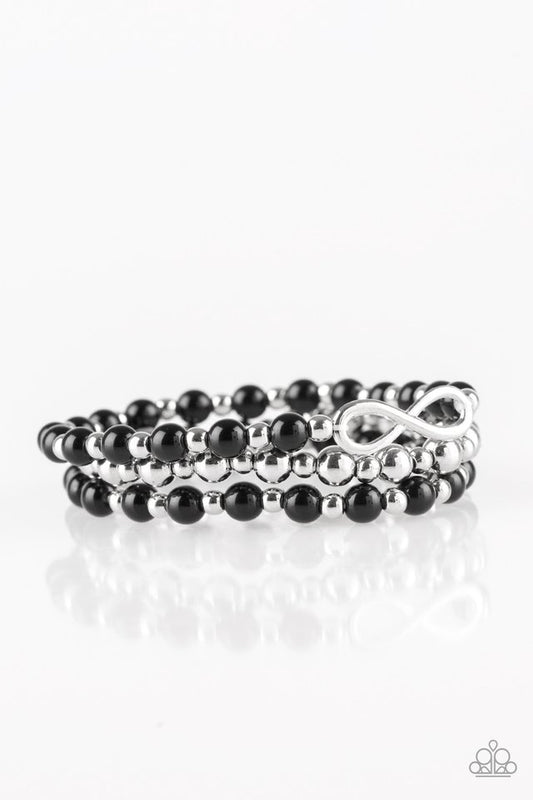 Polished black and shiny silver beads are threaded along stretchy bands, creating colorful layers around the wrist. A dainty silver infinity charm adorns one strand for a whimsical finish.

Sold as one set of three bracelets.