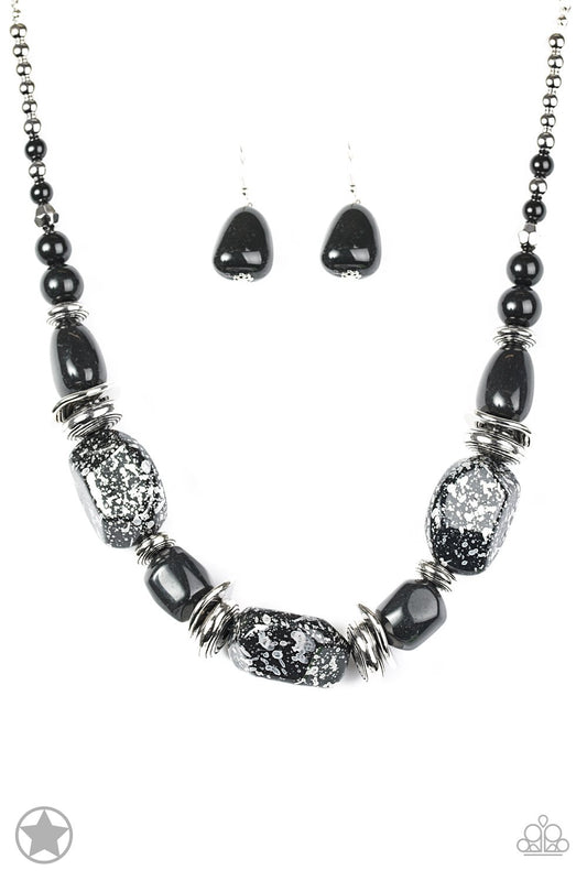 Chunky black beads with speckles of silver and a gorgeous glazed finish are threaded together with thick silver rings and smooth black beads.  Features an adjustable clasp closure.&nbsp;&nbsp;Includes a pair of matching earrings.