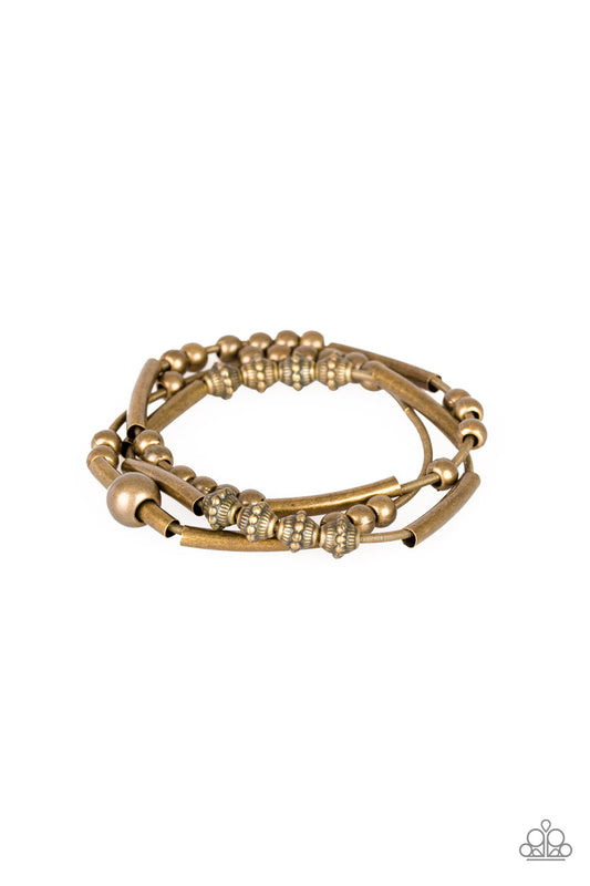 A collection of mismatched brass beads are threaded along three stretchy spring-like wires for a sleek industrial look.

Sold as one set of three bracelets.