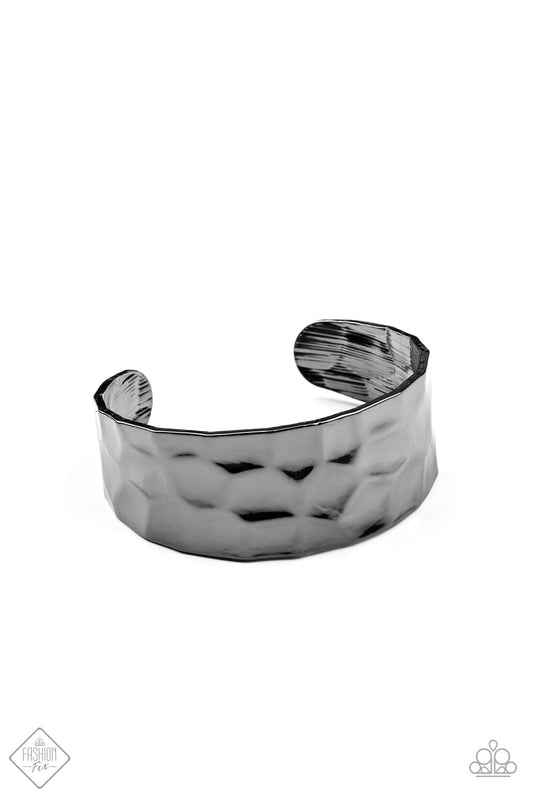A shimmery gunmetal cuff hammered in texture wraps around the wrist for a bold pop of industrial inspiration.  Sold as one individual bracelet.