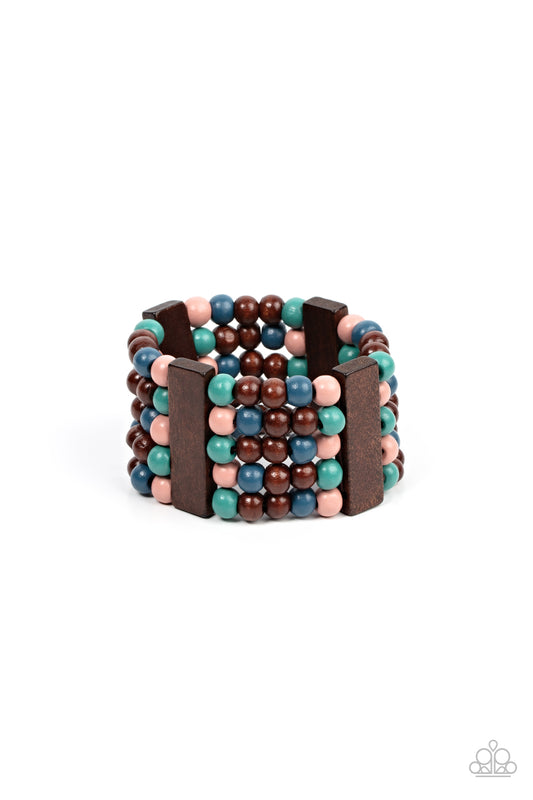 Colorful layers of blue, pink, brown, and turquoise wooden beads are threaded along stretchy bands between brown wooden bars creating stacks of subtle bliss around the wrist.  Sold as one individual bracelet.