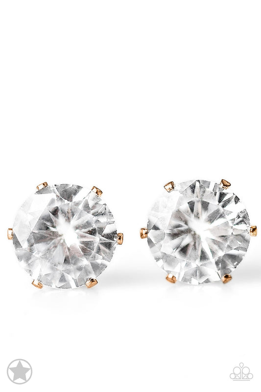 A sparkling white rhinestone is nestled inside a classic gold frame for a timeless look. Earring attaches to a standard post fitting.  Sold as one pair of post earrings.