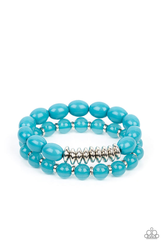 Infused with silver accents, rows of glassy and acrylic blue beads are threaded along stretchy bands around the wrist, resulting in a refreshing pop of color.  Sold as a pair of bracelets.
