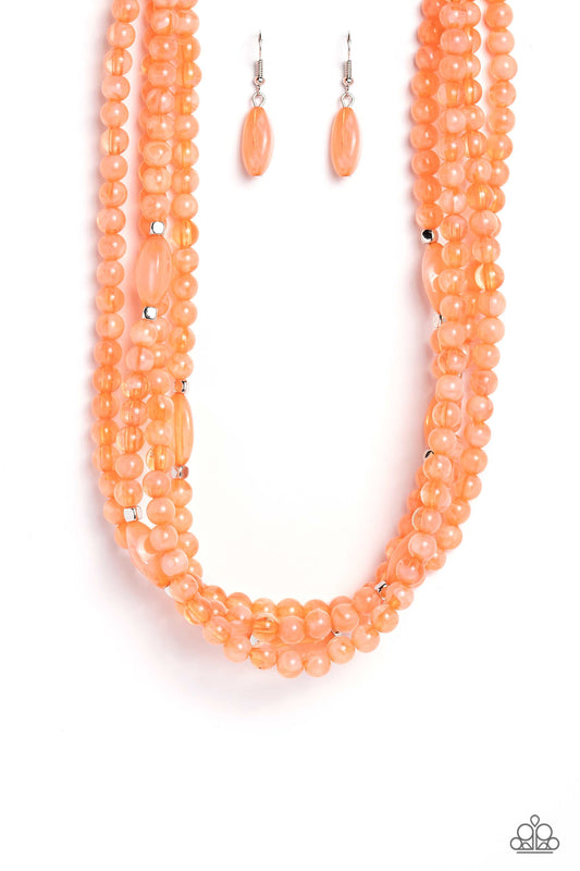 Varying in shape and color, a collection of milky round and oval Peach Pink beads are threaded along invisible wires below the collar. Shiny silver cube beads are sprinkled throughout the strands, adding hints of shimmer to the vibrant layers. Features an adjustable clasp closure.  Sold as one individual necklace. Includes one pair of matching earrings.