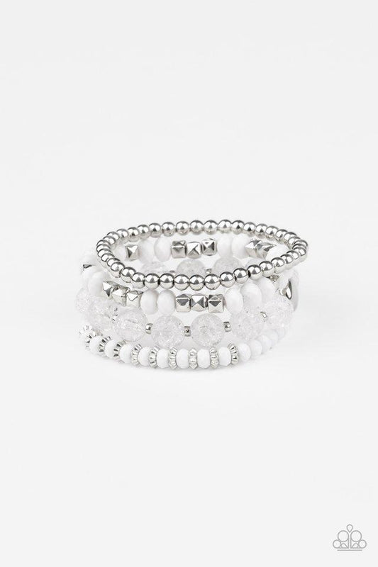 A mismatched assortment of silver, white, and crackling white glass-like beads are threaded along stretchy bands around the wrist, creating colorful layers.

Sold as one set of four bracelets.