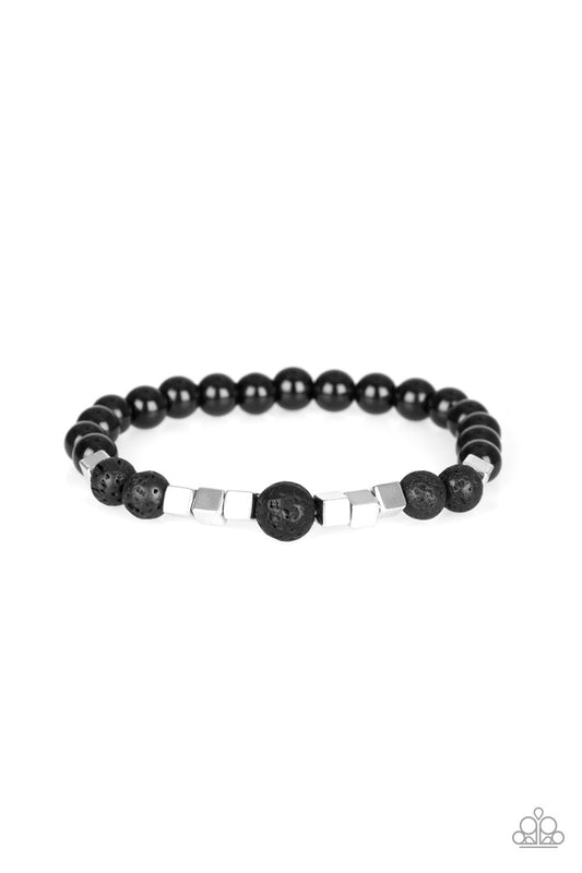 A collection of glassy black beads, earthy lava rock beads, and shimmery silver cubes are threaded along a stretchy band around the wrist for a seasonal flair.  Sold as one individual bracelet.