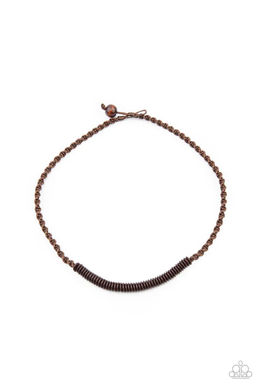A dainty row of black wooden discs are knotted in place along a strand of brown cording that decoratively braids around the neck. Features a button loop closure.  Sold as one individual necklace.