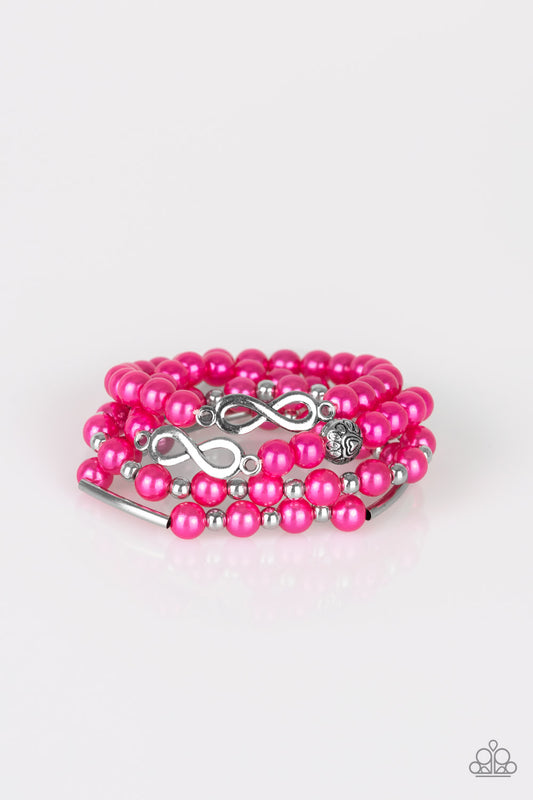 Infused with an array of silver accents, a collection of pink pearls and silver infinity charms are threaded along stretchy bands around the wrist for a glamorous look.

Sold as one set of three bracelets.