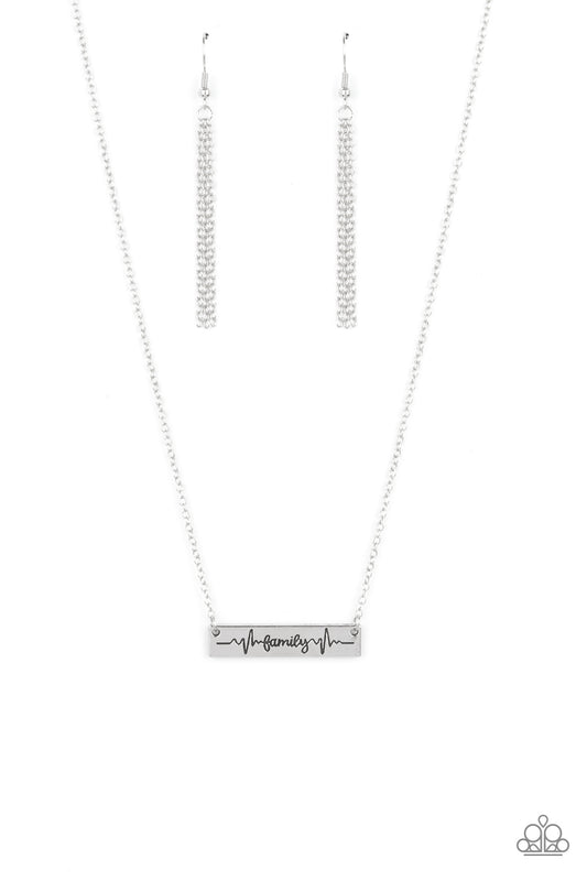 The word "Family," is inscribed between symbolic life lines on a rectangular silver plate creating an affectionate keepsake on a dainty silver chain below the collar. Features an adjustable clasp closure.  Sold as one individual necklace. Includes one pair of silver fringe earrings.