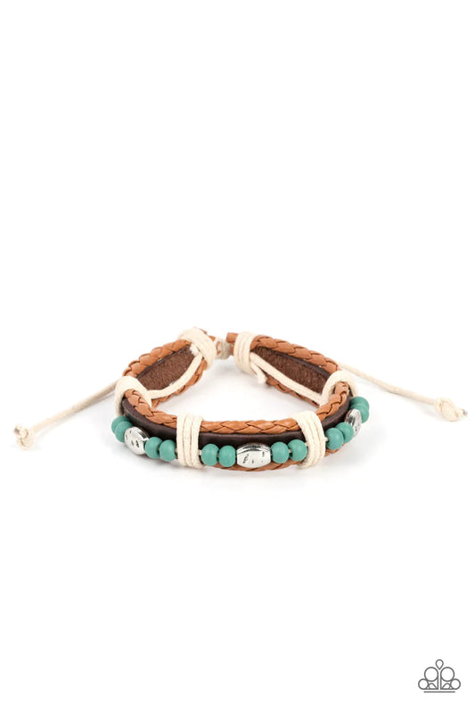 Blue wooden beads and textured silver accents are threaded along a natural cord atop a dark brown leather band. Light brown braided leather bands create a border as the collection is wrapped in sections with natural cording for a handcrafted look. Features an adjustable sliding knot closure.  Sold as one individual bracelet.