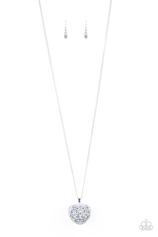 Brushed in a neutral gray finish, flowery filigree coalesces into a locket-like pendant at the bottom of a shimmery silver chain. A glassy white rhinestone dots the vintage inspired frame for a whimsical finish. Features an adjustable clasp closure.  Sold as one individual necklace. Includes one pair of matching earrings.